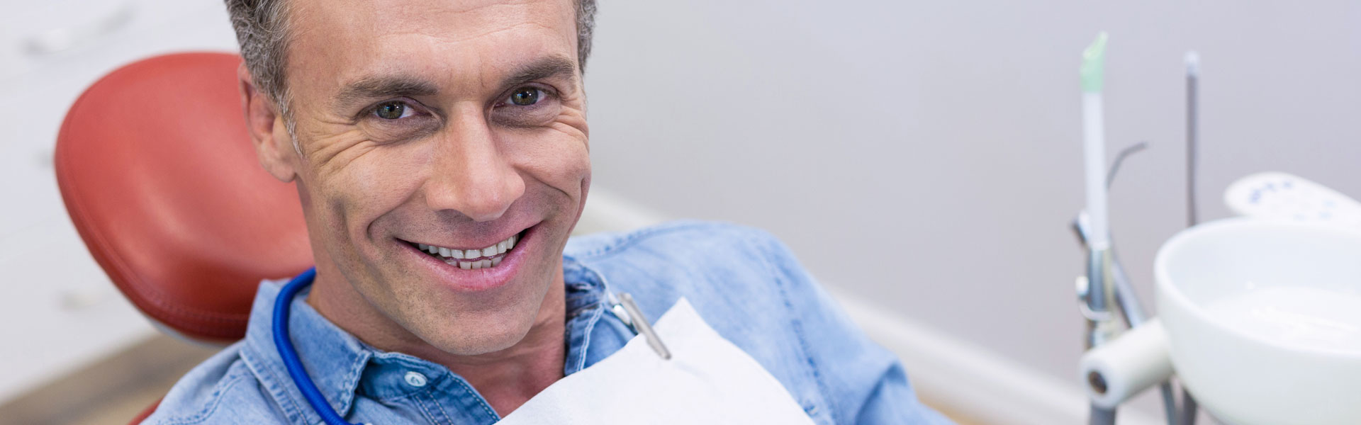 Happy senior man after having dental implants treatment