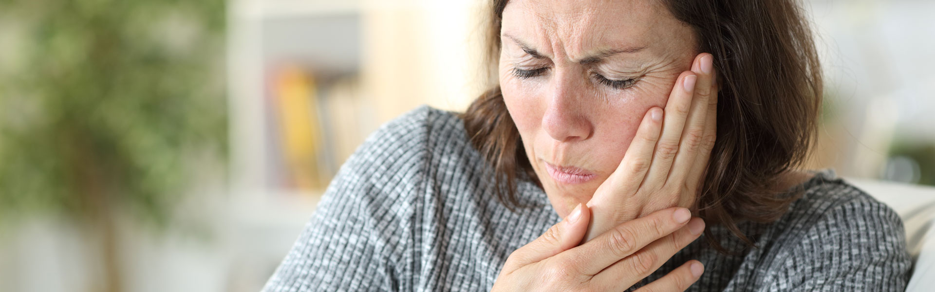 Middle age woman in pain suffering from toothache